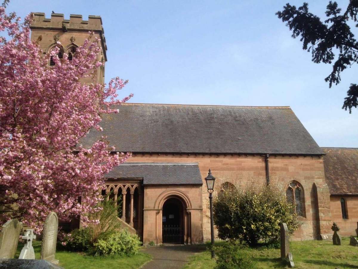 St Bartholomew's Church, Grimley, with flowers and trees